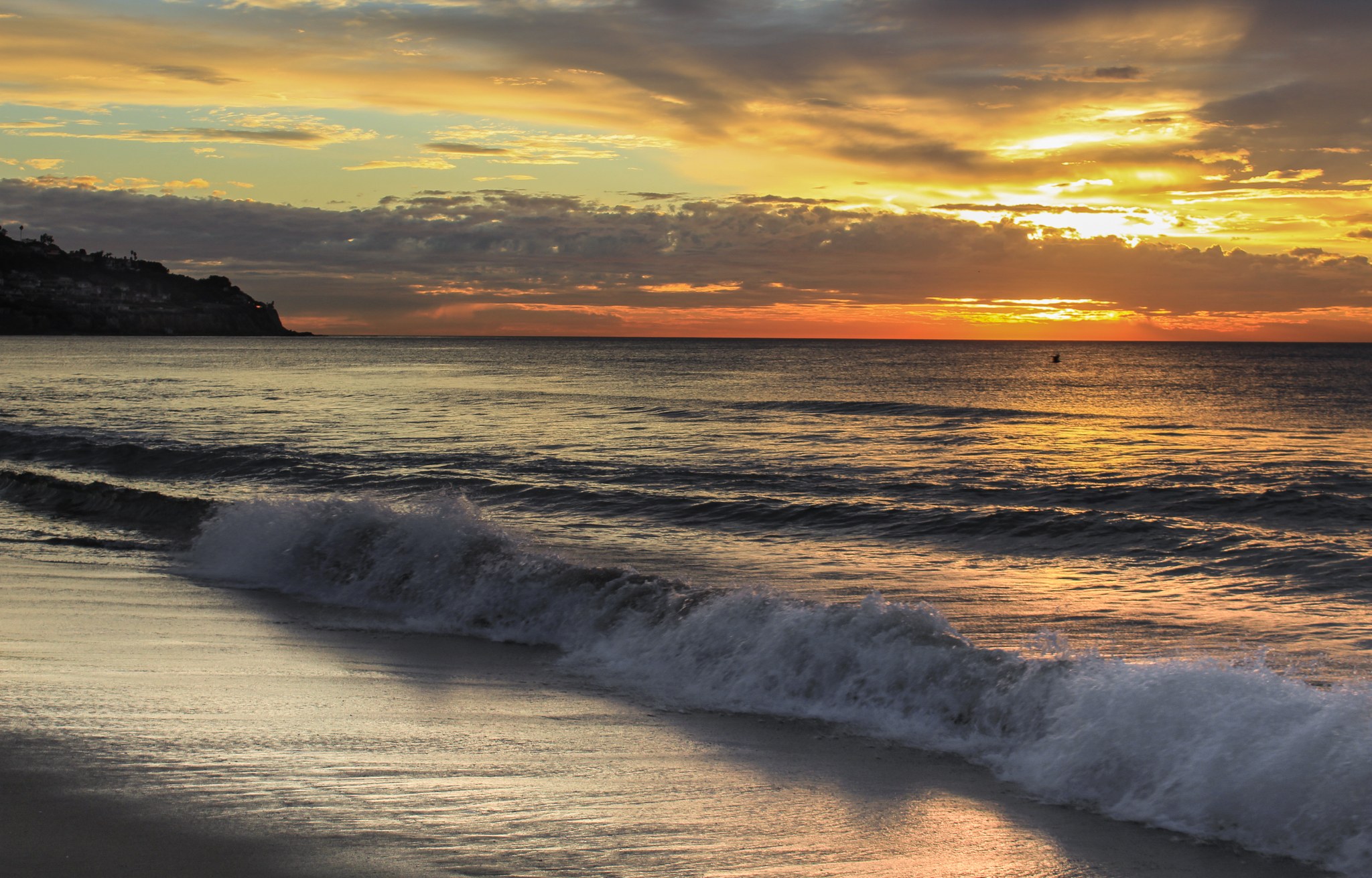 Sunset and breaking waves at Torrance Beach, photographed December 24, 2020.